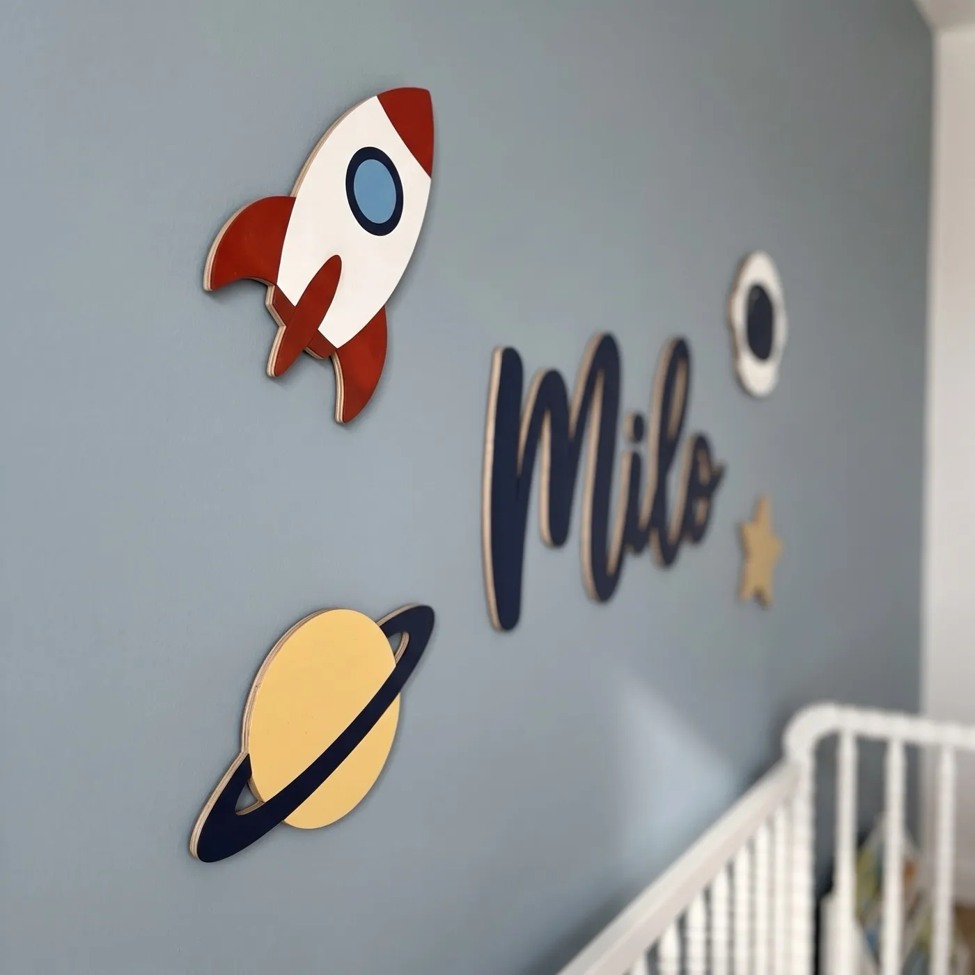 Side view of a wooden space name sign showing the thin plywood edge